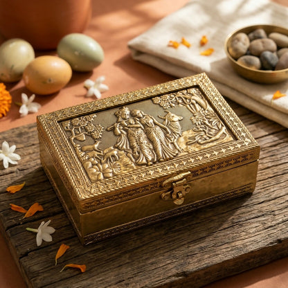 Side view of golden metal jewelry box with intricate border
