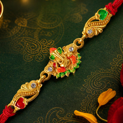 Gold-Toned Lord Ganesha Rakhi with Orange-Green Enamel, Crystal Accents & Red Thread