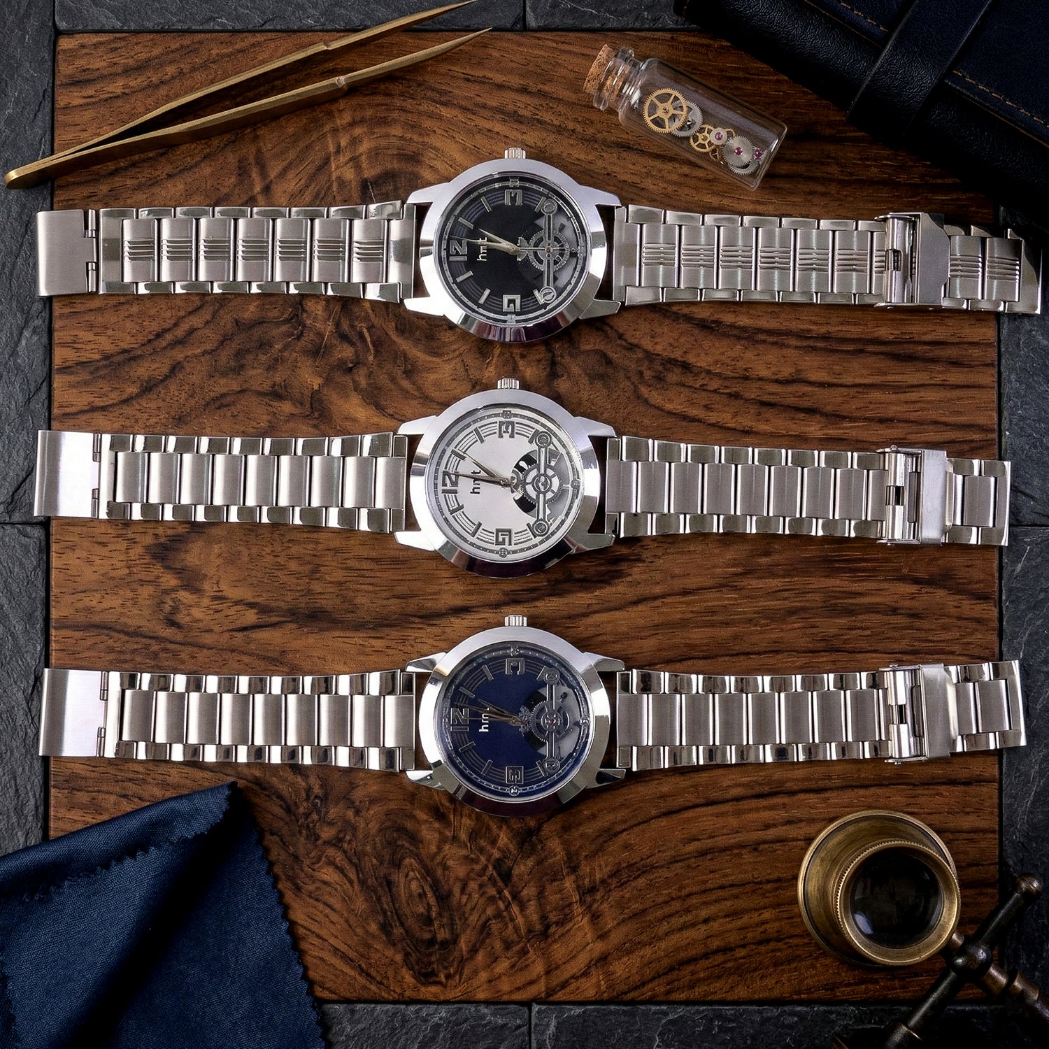 Analog wrist watch with skeleton dial and metal strap showing mechanical detail