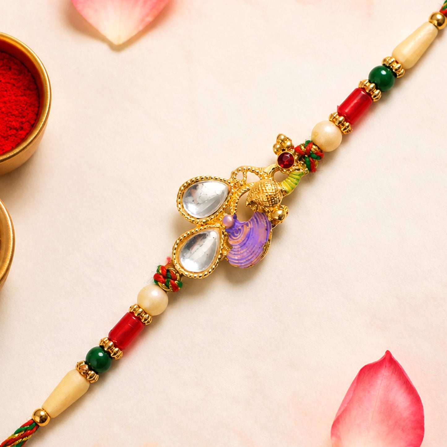 Floral Kundan Pendant Rakhi with Purple Peacock Accent