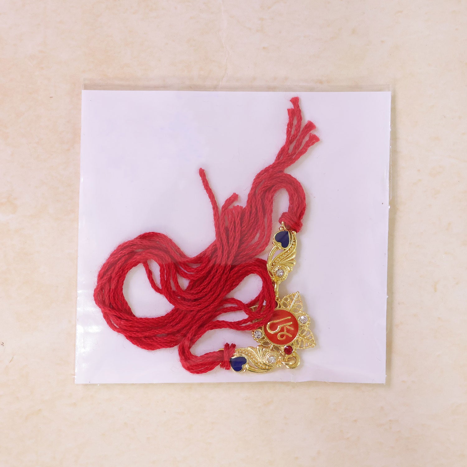 Festive Rakhi featuring Shri Plaque, leaf detail and thread style for Product Display