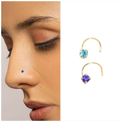 Close-up of gold plated clear crystal nose pin with four-prong setting