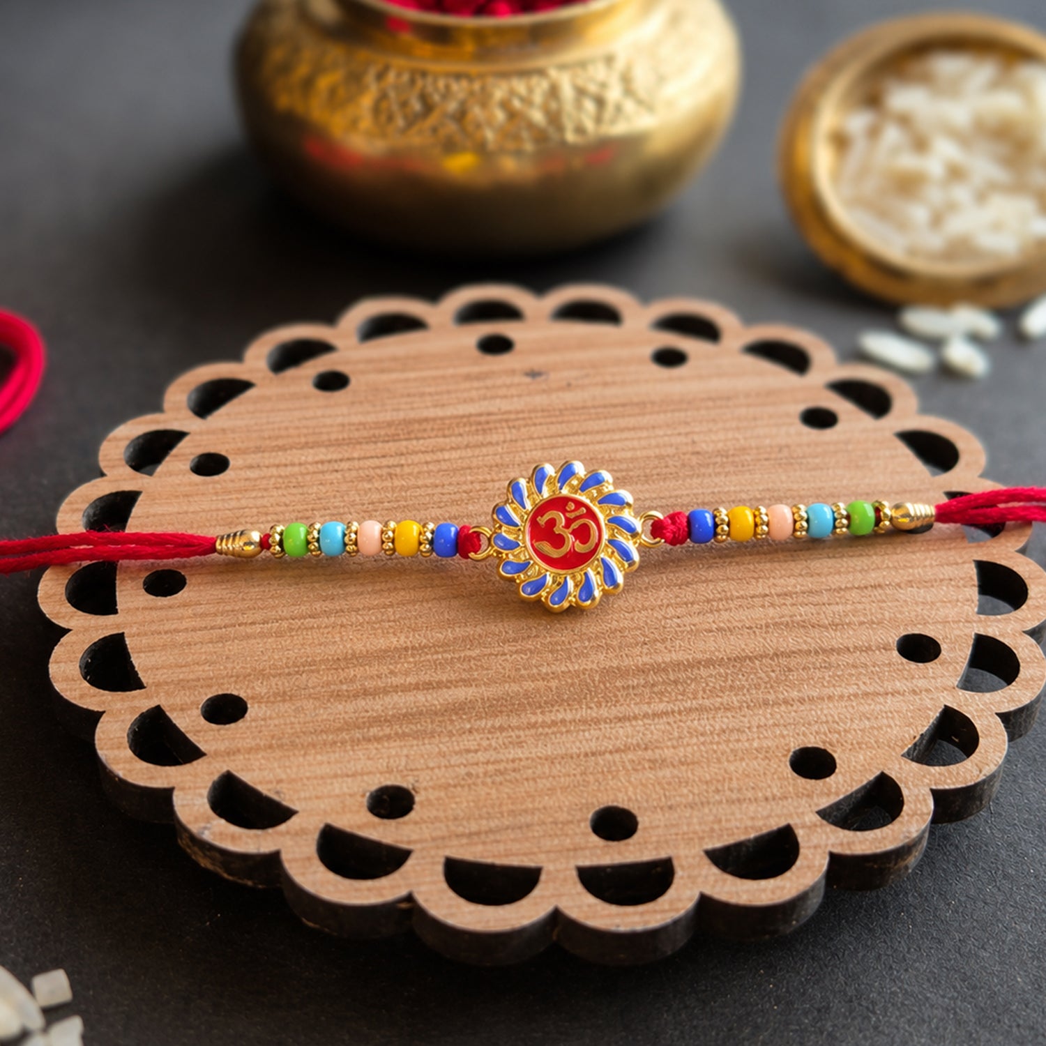 Premium OM Symbol Rakhi with colorful beads and red thread