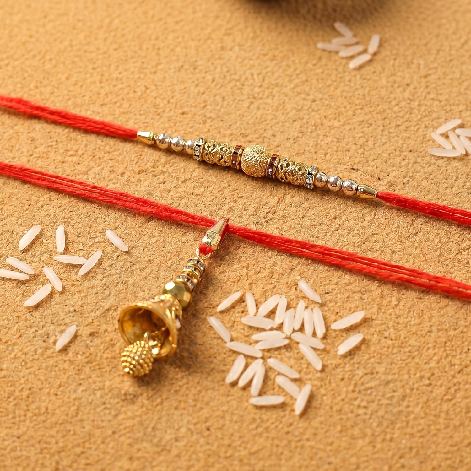 Close-up of golden bhabhi rakhi with pearl drop latkan