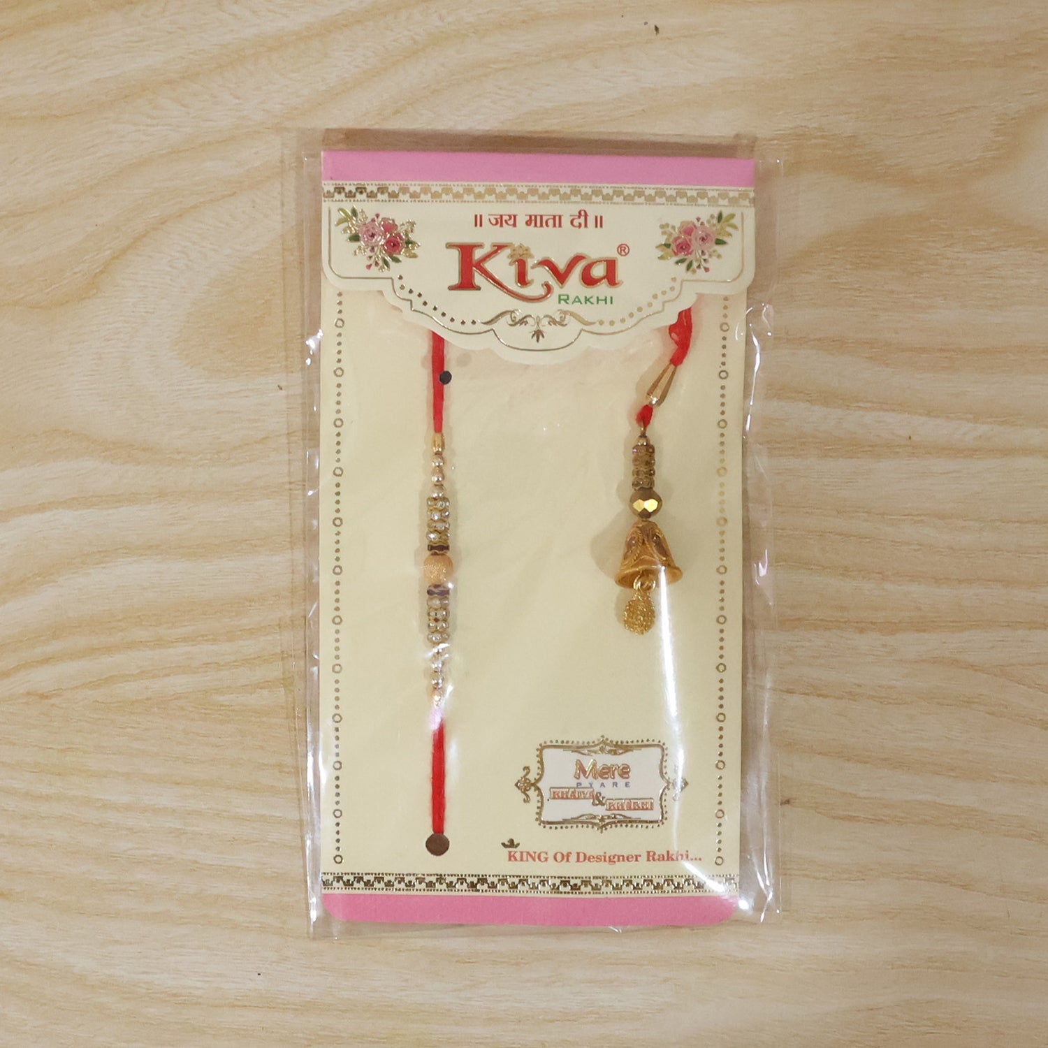 Side view of golden bhabhi rakhi with pearl drop latkan