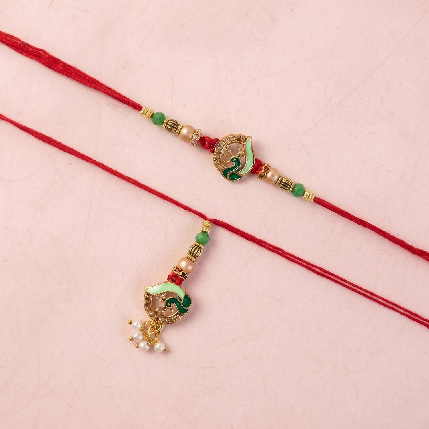 Pearl drop accent on Peacock Stone Bhabhi Rakhi