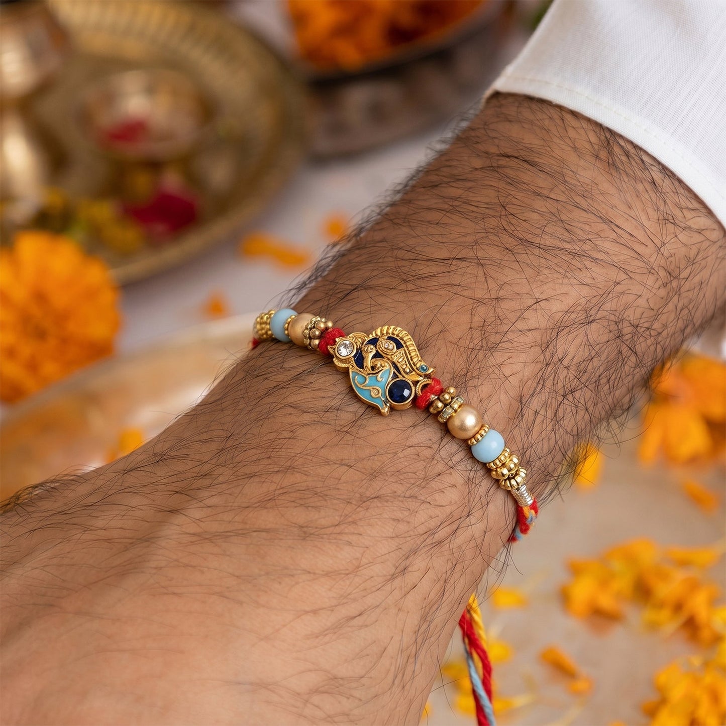 Close-up of Pearl Bead Bhabhi Rakhi colorful latkan detail