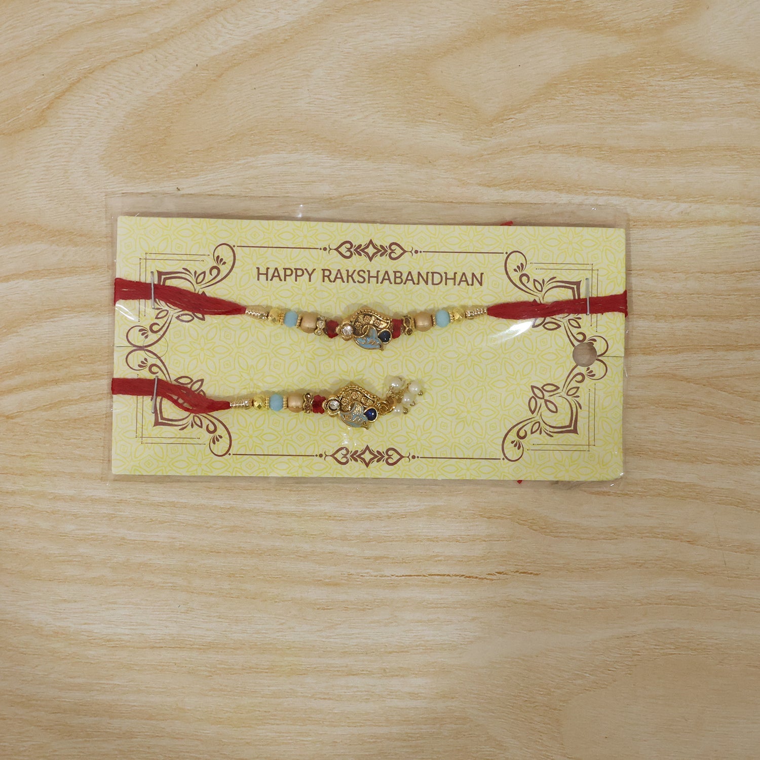 Pearl Bead Bhabhi Rakhi angled close-up with latkan colors
