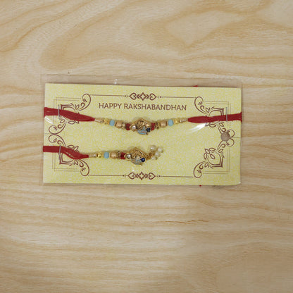 Pearl Bead Bhabhi Rakhi angled close-up with latkan colors