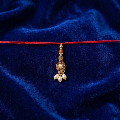 Top view of Antique stone Bhabhi Rakhi with pearl beads