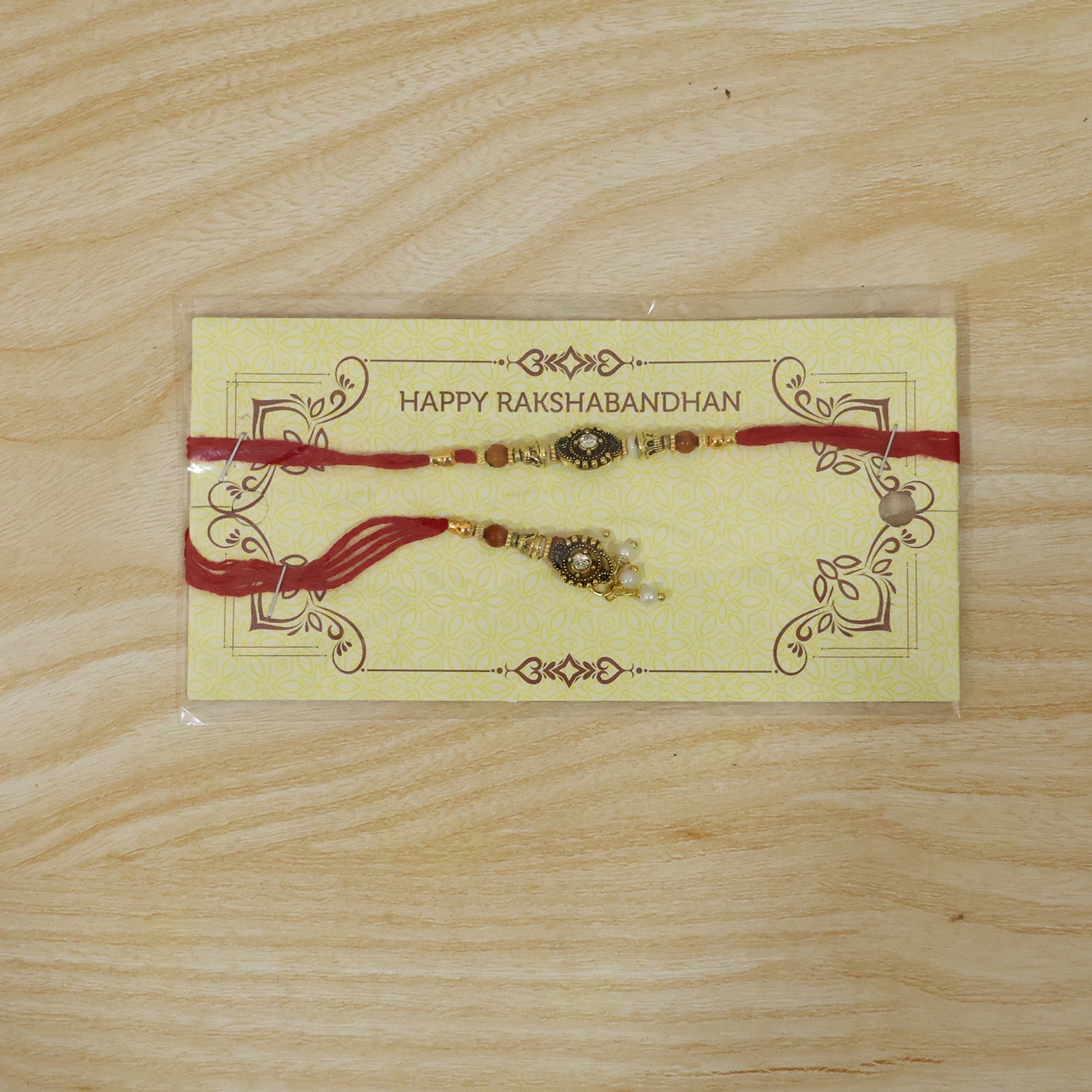 Antique stone Bhabhi Rakhi displayed with pearl bead accents