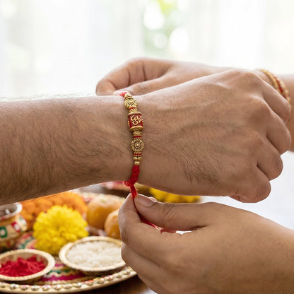 Red Gold Bead Bhabhi Rakhi displayed on white background