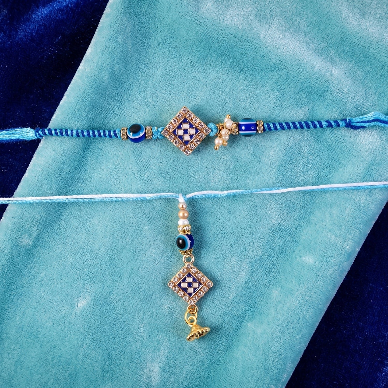 Close-up of Pearl Bhabhi Rakhi twin charm detail