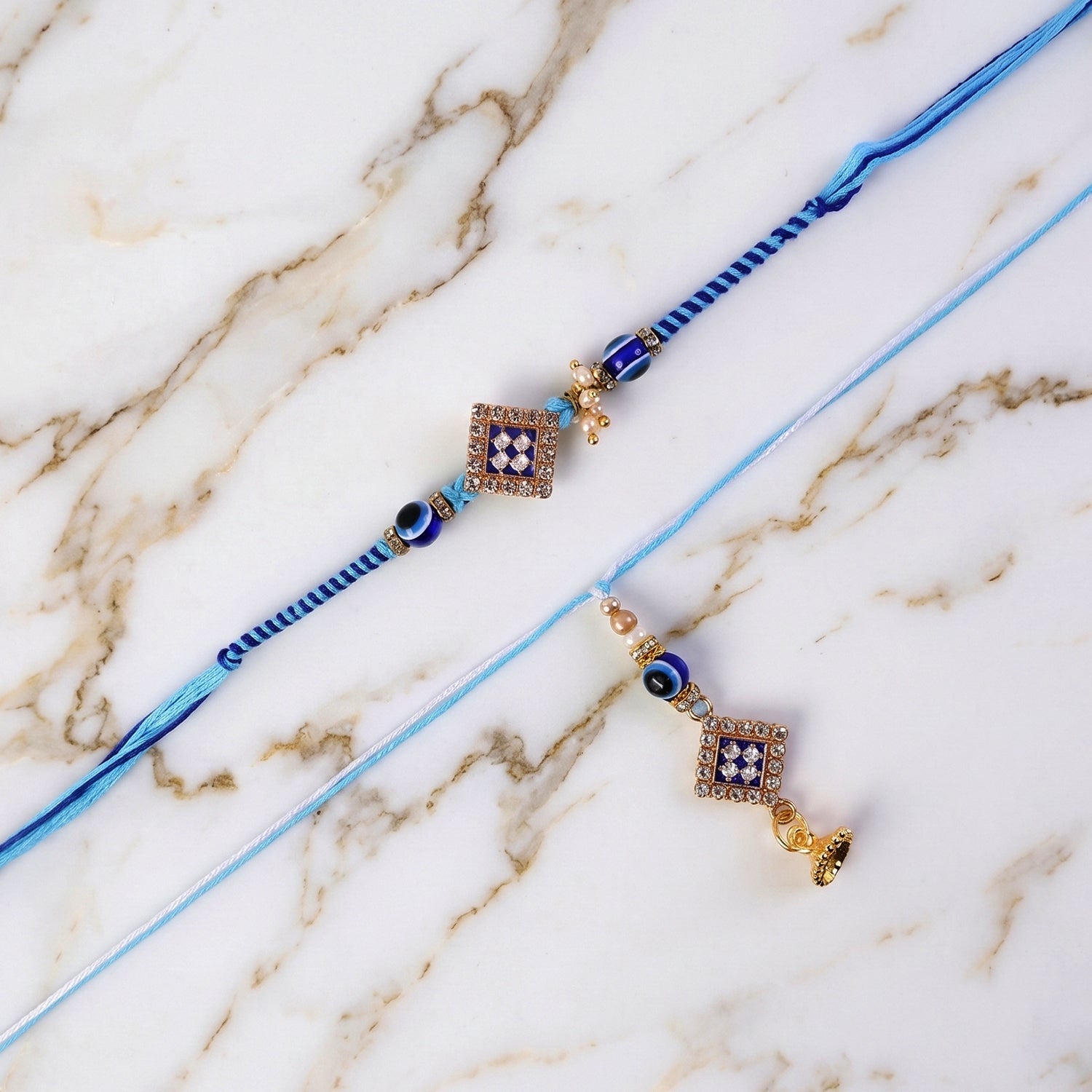 Packaged Pearl Bhabhi Rakhi with Twin Charm Design front view