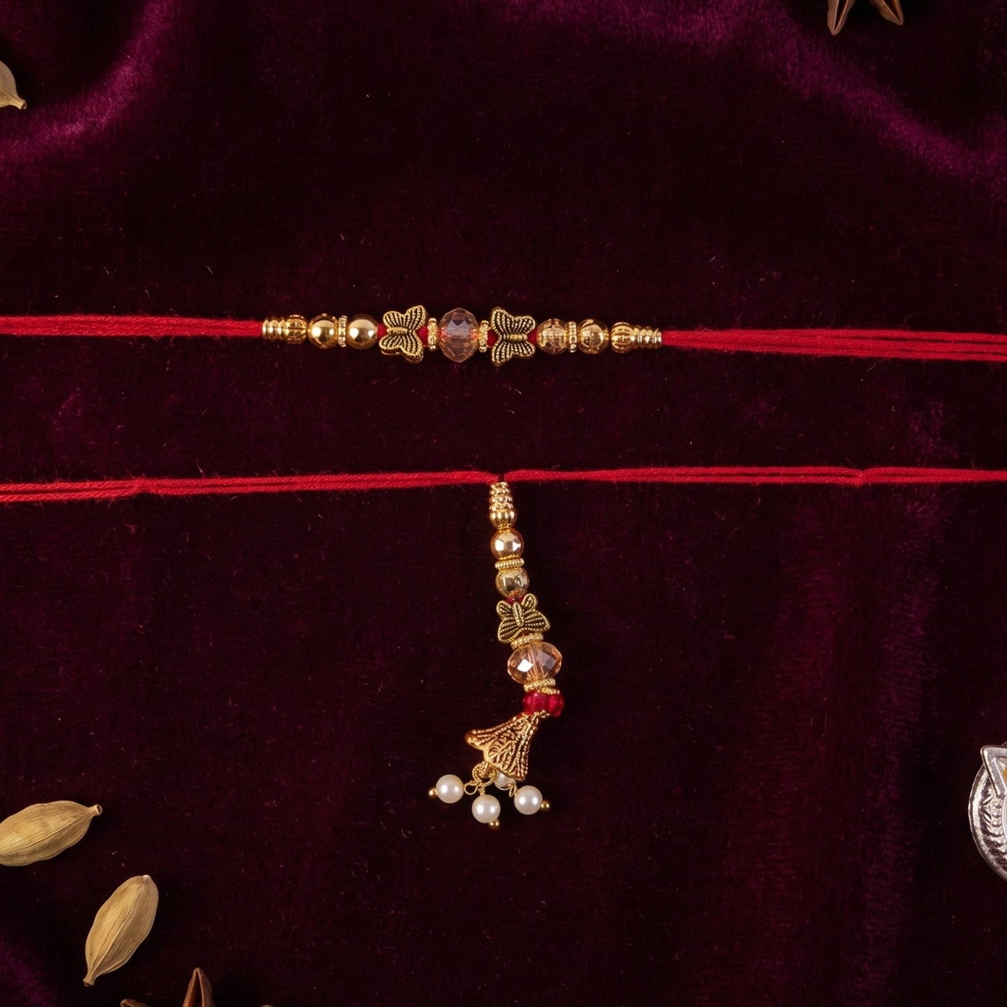 Sleek Stone Bhabhi Rakhi with Golden Latkan close-up on white background