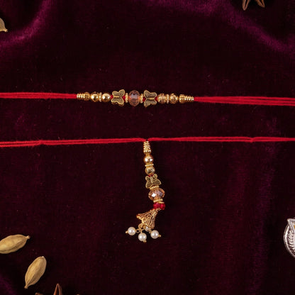 Sleek Stone Bhabhi Rakhi with Golden Latkan close-up on white background