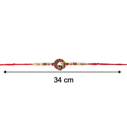 Elegant Peacock Motif Bhabhi Rakhi displayed on surface
