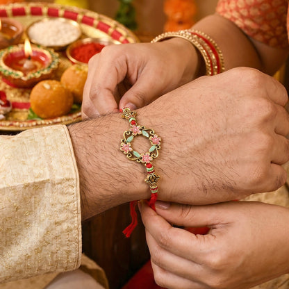 Hand holding Floral Stone Bhabhi Rakhi showing pearl decoration