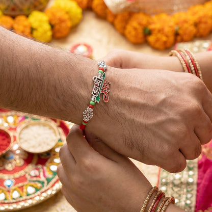 Top view of Bhaiya Bhabhi Rakhi Pair with silver tone charm accents