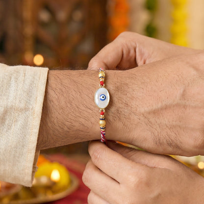 Close up of Evil Eye Bhabhi Rakhi detailing with white beads
