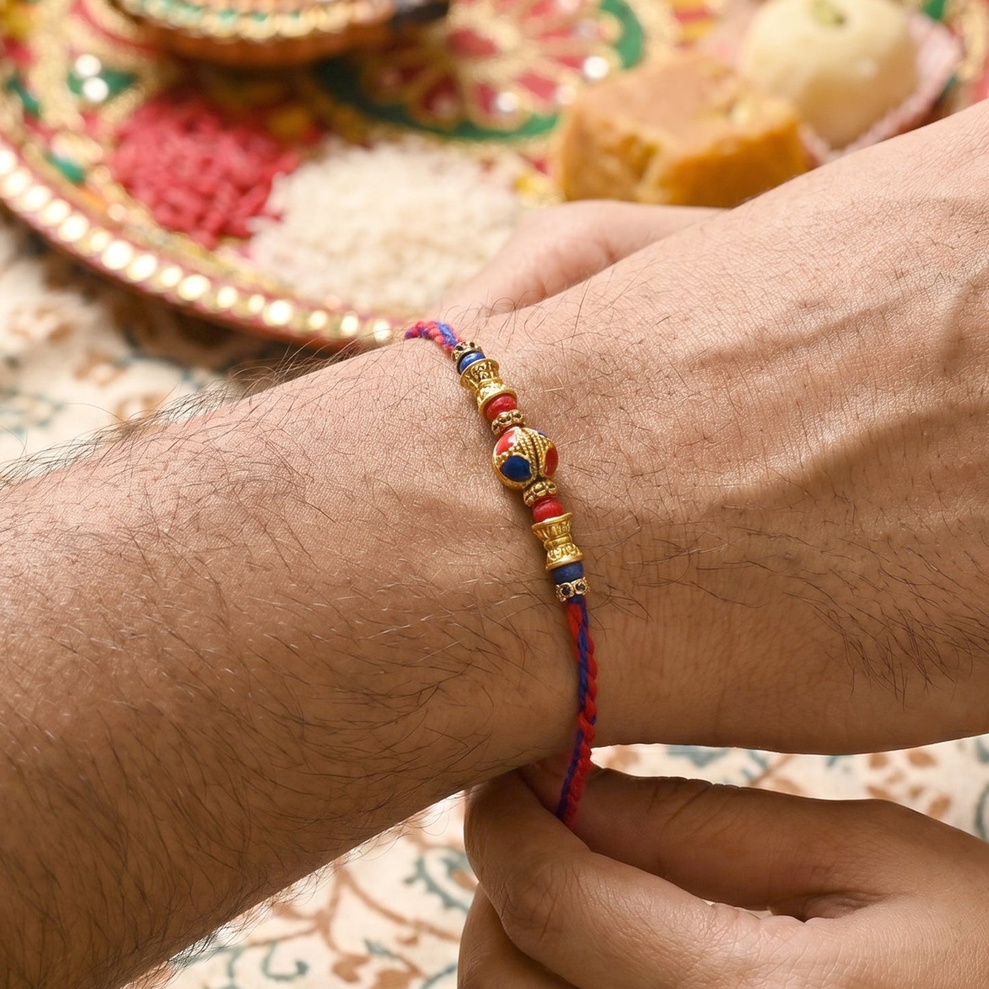 Close-up of Jhumka Latkan on Bhabhi Rakhi bead thread