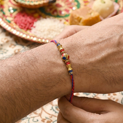 Close-up of Jhumka Latkan on Bhabhi Rakhi bead thread