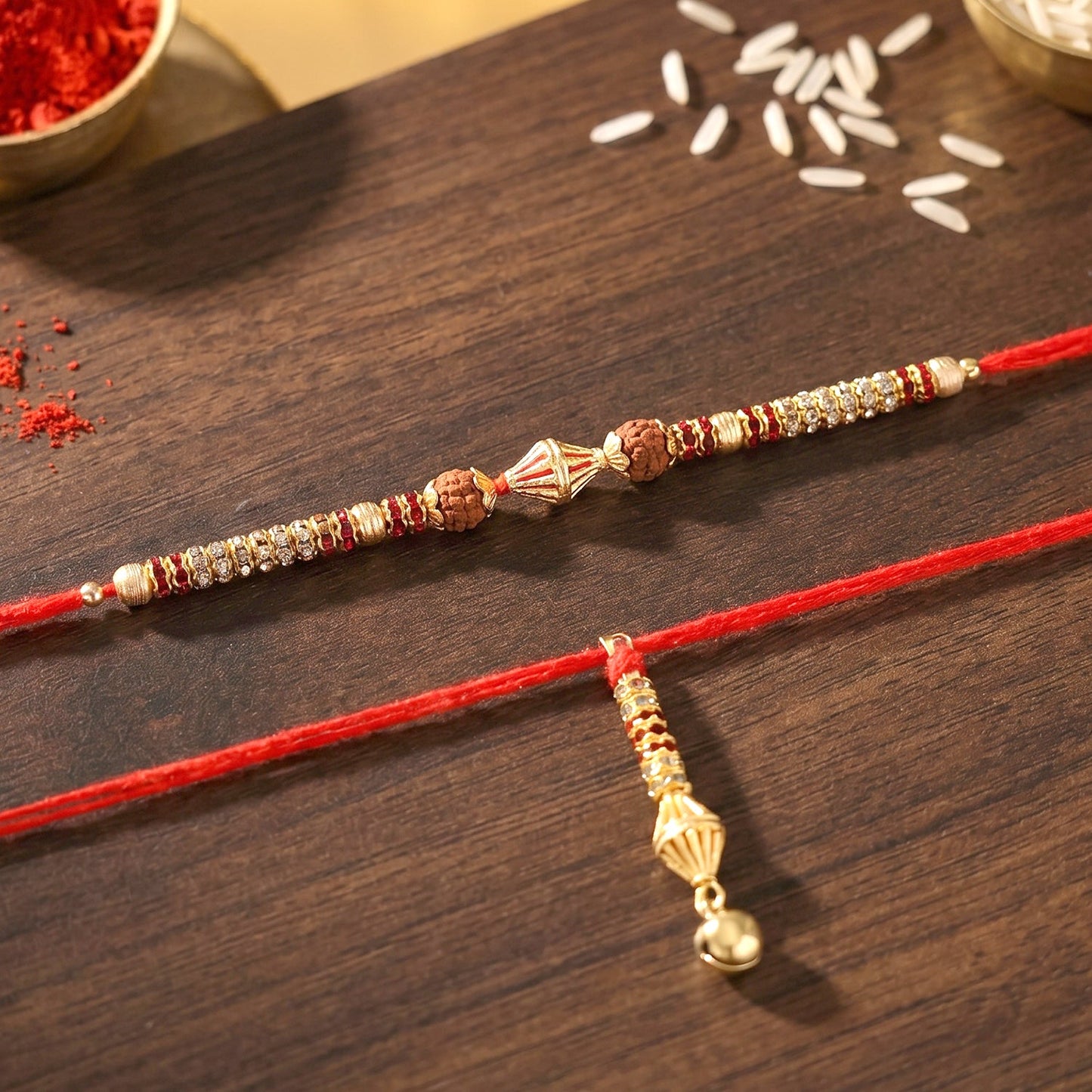 Hand holding Sleek Pearl Bead Bhabhi Rakhi with Gold Latkan