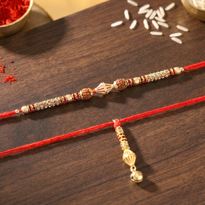 Hand holding Sleek Pearl Bead Bhabhi Rakhi with Gold Latkan