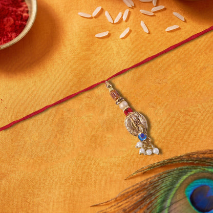 Close-up of Blue Stone Bhabhi Rakhi showing pearl cluster latkan