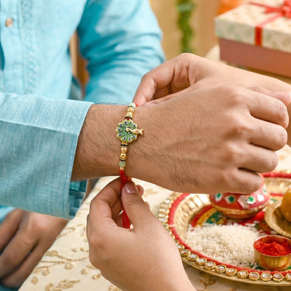 Close-up of green stones and latkan on Peacock Bhabhi Rakhi