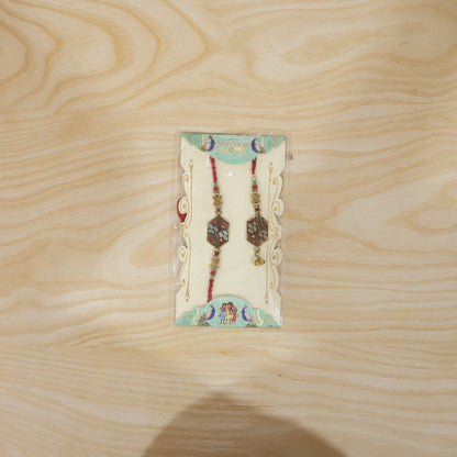 Meenakari Pot Bhabhi Rakhi with threads shown
