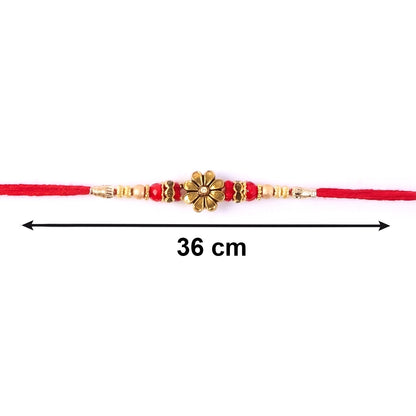 Close-up of pearl beads on golden floral designer Rakhi