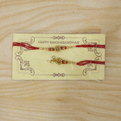 Golden floral designer Rakhi with elegant pearl bead accents