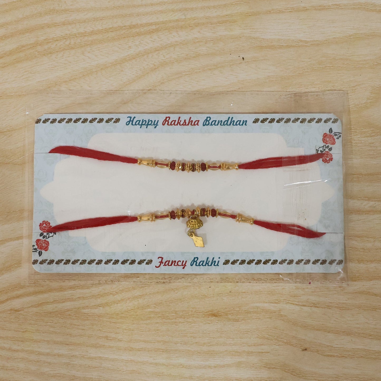 Full display of elegant golden beaded Bhabhi Rakhi on white background