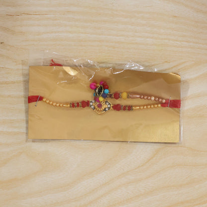 Close-up of colorful beads and thread on Hexagon Stone Designer Rakhi
