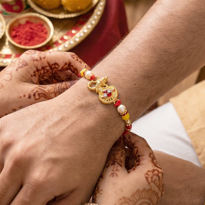 Top view of designer rakhi featuring golden ganesha