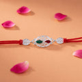 Silver Oval Rakhi – Elegant Design with Red Thread