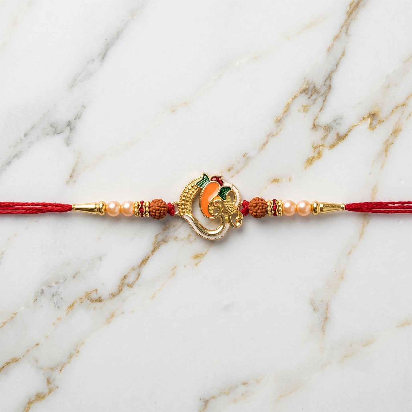 Ganesh motif Rakhi laid out on a festive background