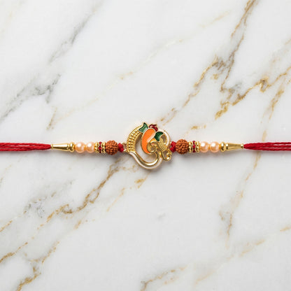Ganesh motif Rakhi laid out on a festive background
