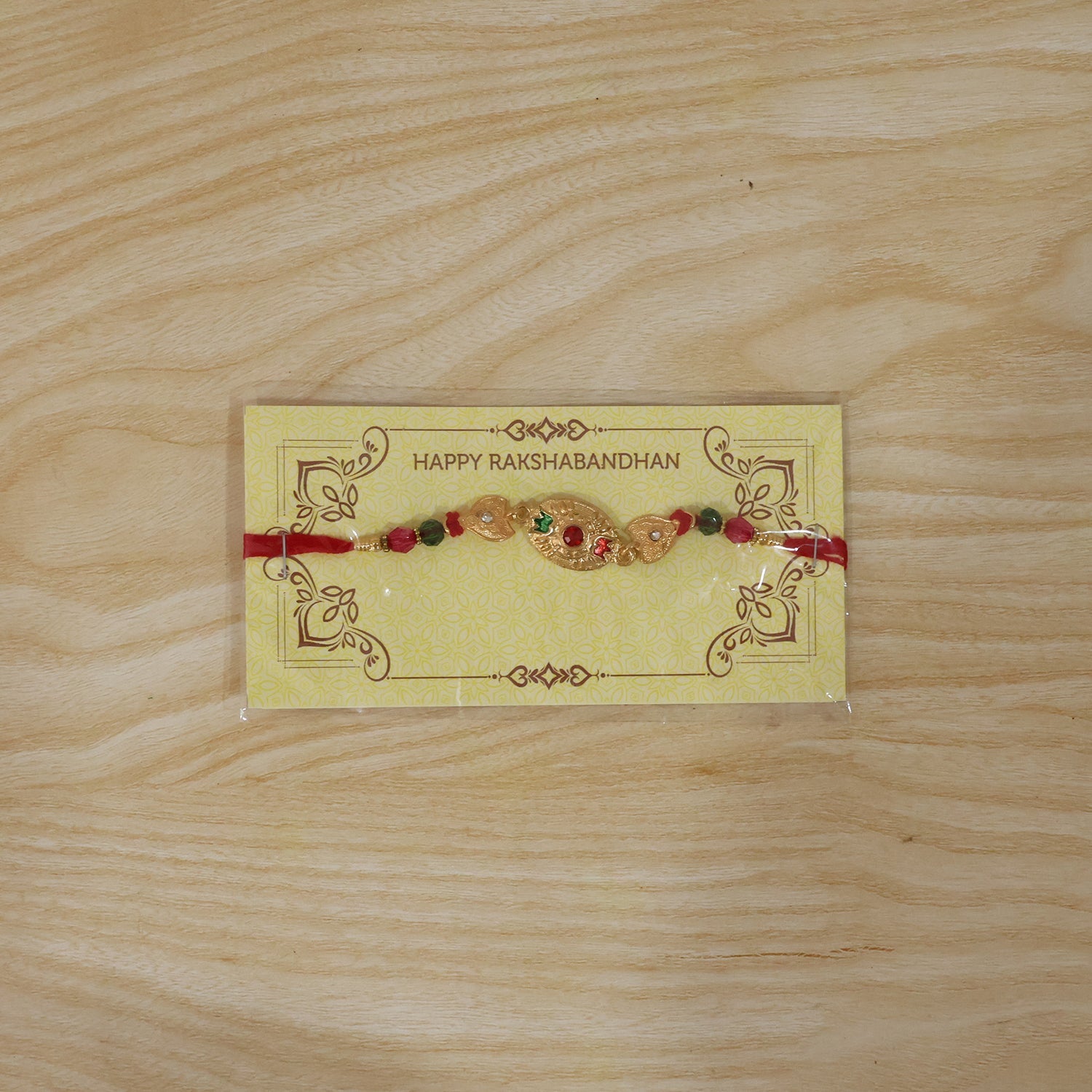 Elegant golden Rakhi with vibrant bead accents