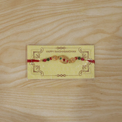Elegant golden Rakhi with vibrant bead accents