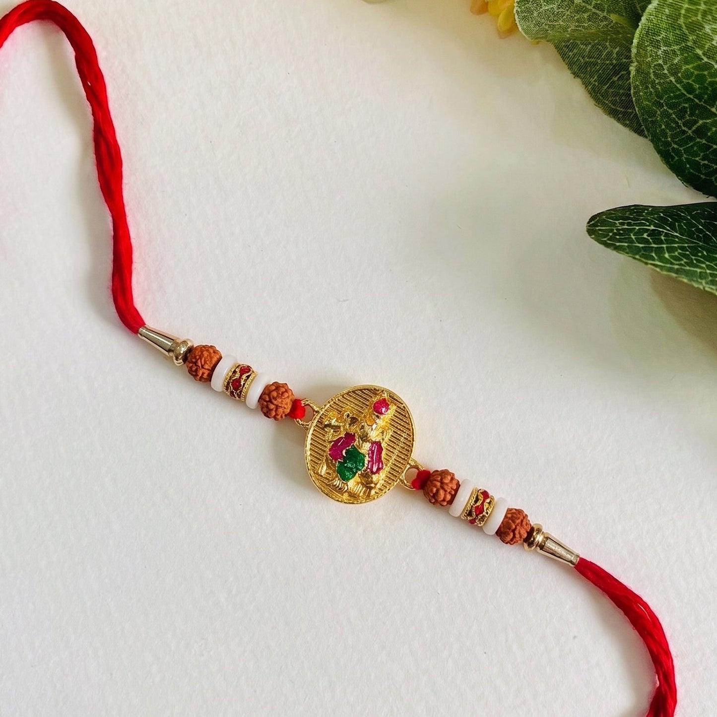 Side view of Lord Krishna rakhi showing centerpiece