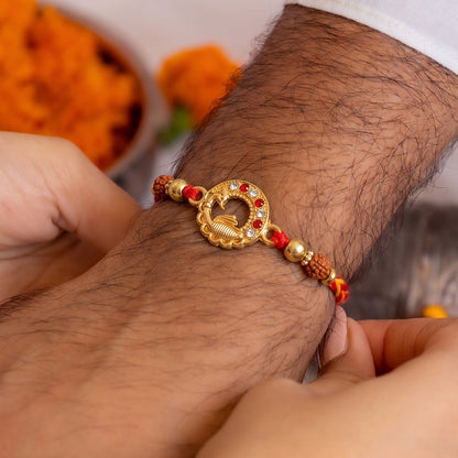 Close-up of decorative beads and golden peacock centerpiece on Rakhi