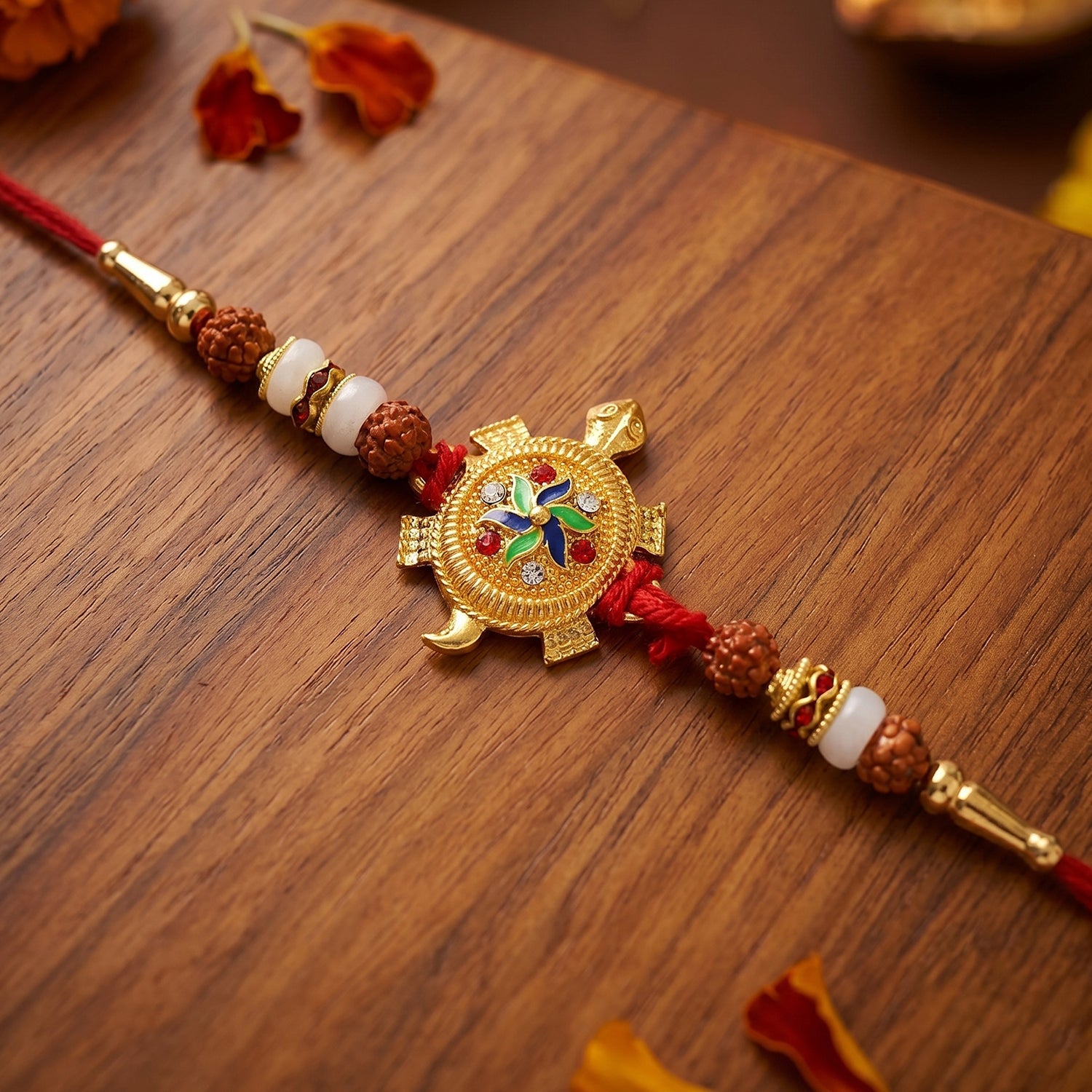 Close-up of turtle centerpiece and decorative Rudraksha beads on Rakhi
