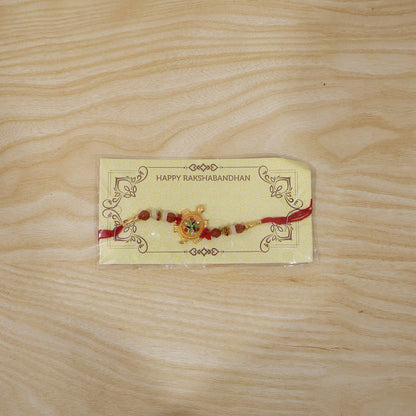 Traditional Rakhi with turtle centerpiece and Rudraksha beads close-up
