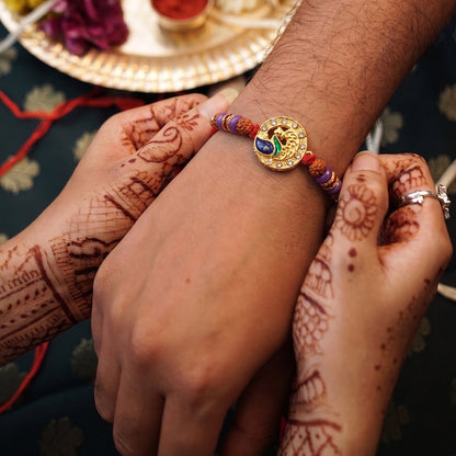 Peacock Design Rakhi displayed on white background