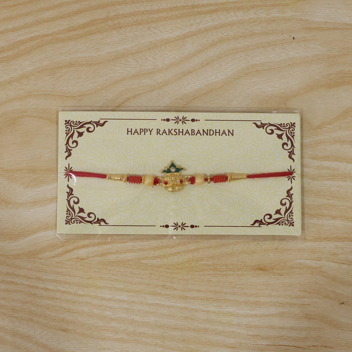 Kalash Design Rakhi laying flat showcasing details