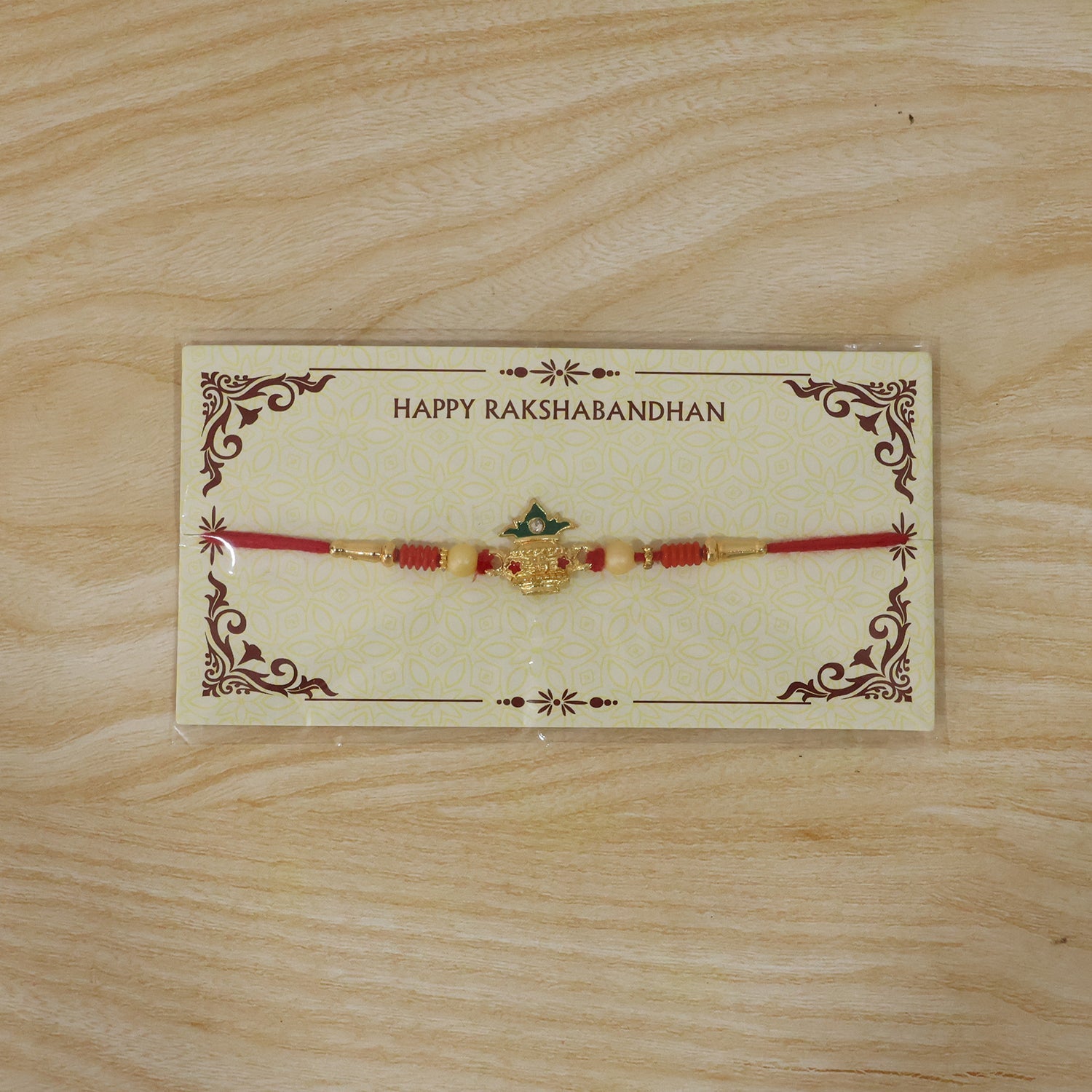 Kalash Design Rakhi laying flat showcasing details