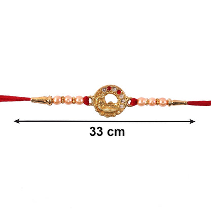 Side view of designer peacock rakhi with decorative beads