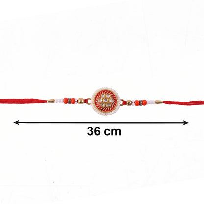 Golden floral rakhi displayed with soft thread details